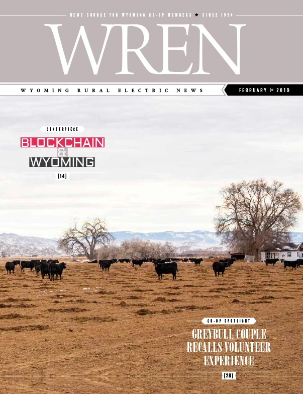 WREN 02-February 2019 Cover Cover of WREN magazine, February 2019, showing a field with grazing cattle, barren trees, distant mountains, and headlines about blockchain in Wyoming and a Greybull couples volunteer experience.