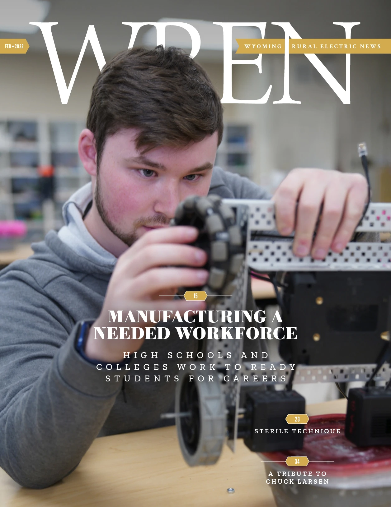 WREN 02-February 2022 Cover A young man adjusts a component on a mechanical device in a workshop setting, featured on the cover of Wyoming Rural Electric News magazine.