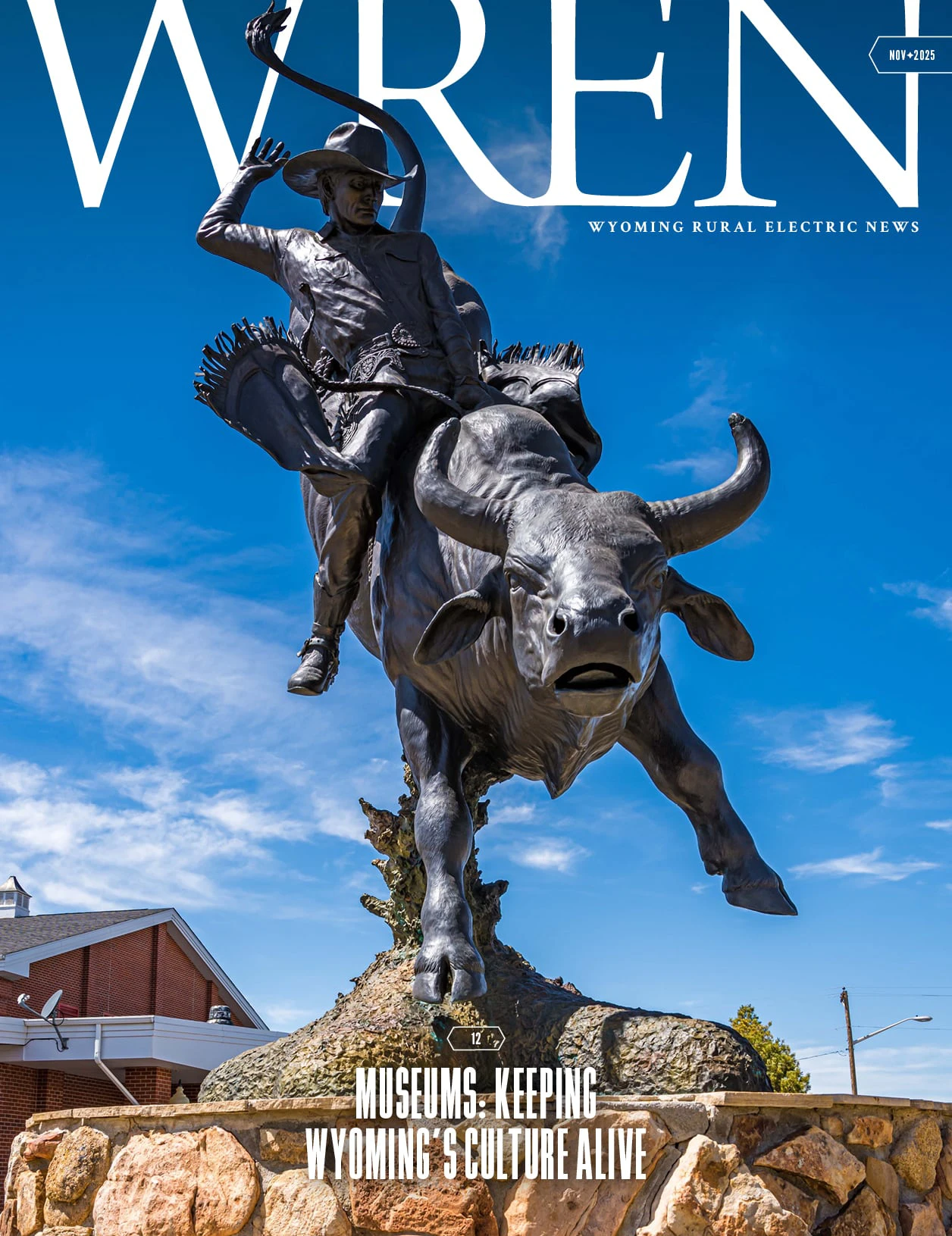 WREN 11-November 2025 Cover A bronze statue of a cowboy riding a bucking bull is featured under a clear blue sky. The statue stands in front of a red brick building and is the cover image of WREN magazine with the headline, Museums—Keeping Wyomings Culture Alive.
