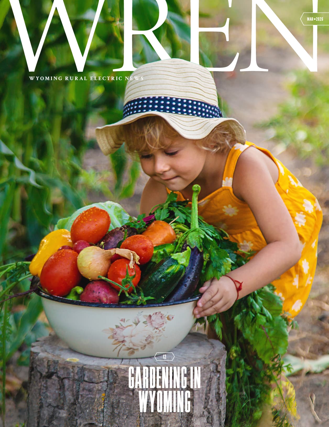 A young child in a yellow dress and sunhat examines a large bowl filled with freshly harvested vegetables outdoors. Text reads Gardening in Wyoming.